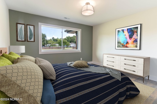 bedroom with dark hardwood / wood-style floors