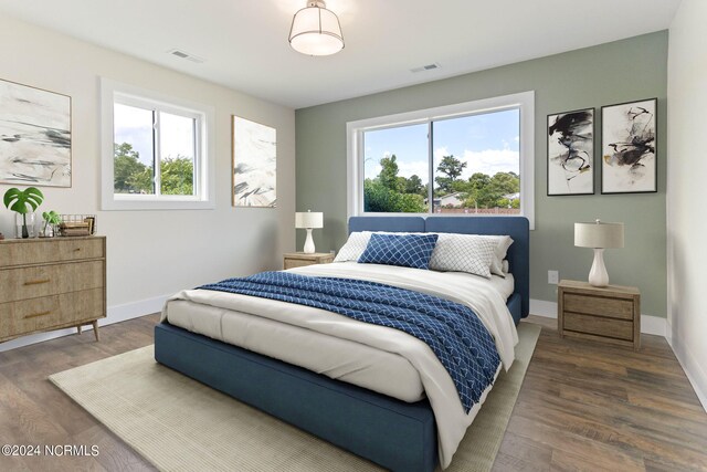 bedroom with dark wood-type flooring