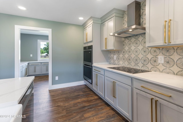 kitchen with gray cabinetry, decorative backsplash, black electric stovetop, and wall chimney range hood