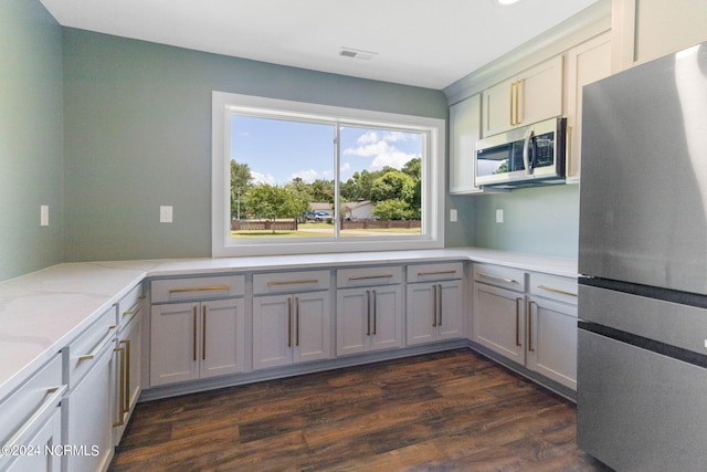 kitchen featuring dark hardwood / wood-style floors, gray cabinets, and appliances with stainless steel finishes