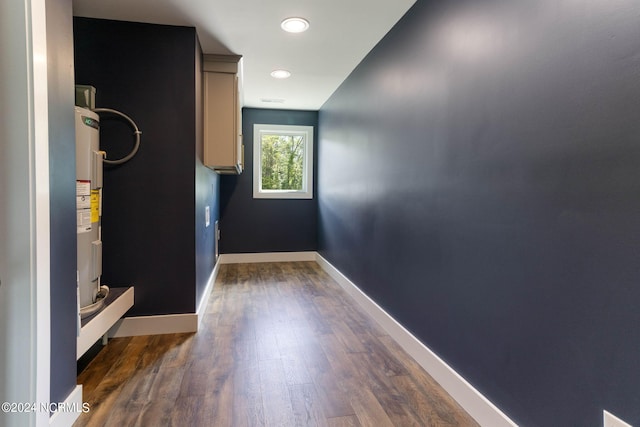 hallway featuring dark hardwood / wood-style floors and water heater