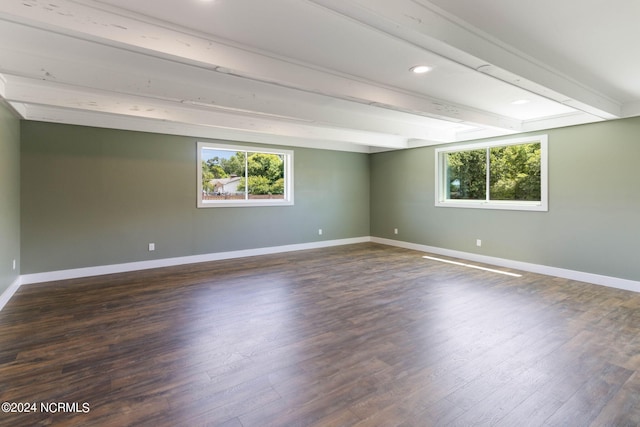 unfurnished room featuring beam ceiling and dark hardwood / wood-style floors