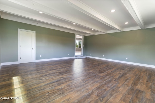 unfurnished room with beamed ceiling and dark hardwood / wood-style floors