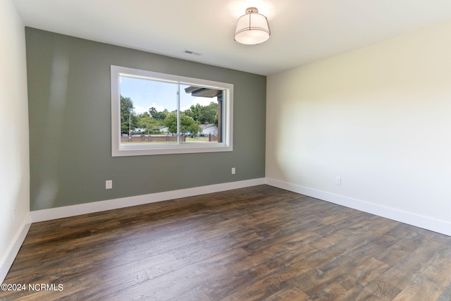 spare room with dark hardwood / wood-style floors