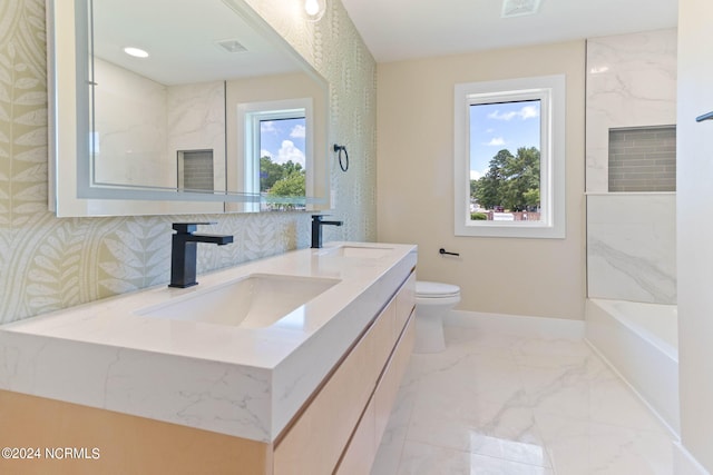 bathroom featuring vanity, toilet, and a healthy amount of sunlight