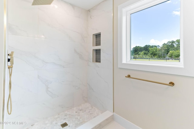 bathroom with tiled shower