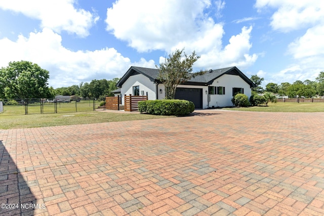 view of front of home with a garage and a front yard