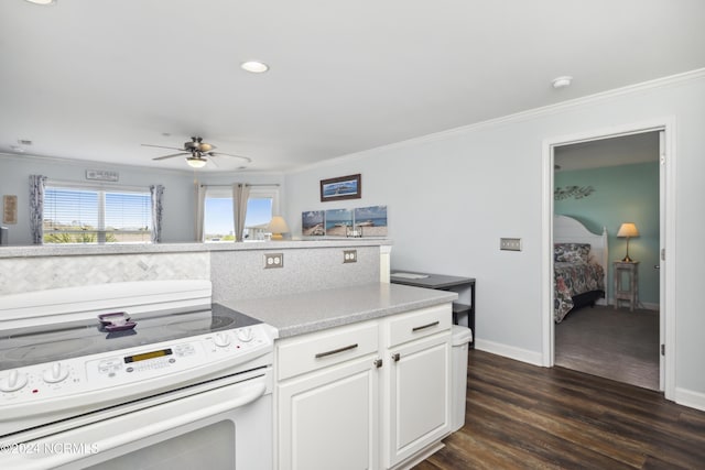 kitchen featuring ceiling fan, crown molding, white range with electric cooktop, dark hardwood / wood-style floors, and white cabinetry