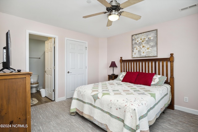 bedroom with hardwood / wood-style floors, ceiling fan, and ensuite bathroom