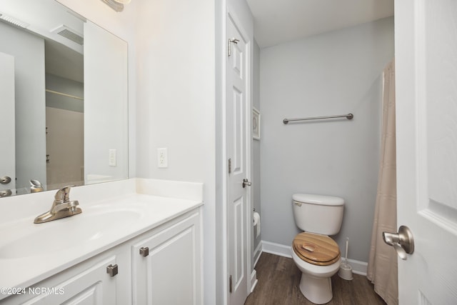 bathroom with hardwood / wood-style flooring, vanity, and toilet