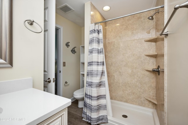 bathroom featuring vanity, a shower with shower curtain, and toilet