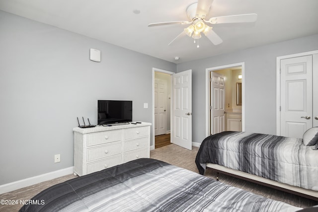 bedroom with ensuite bath and ceiling fan