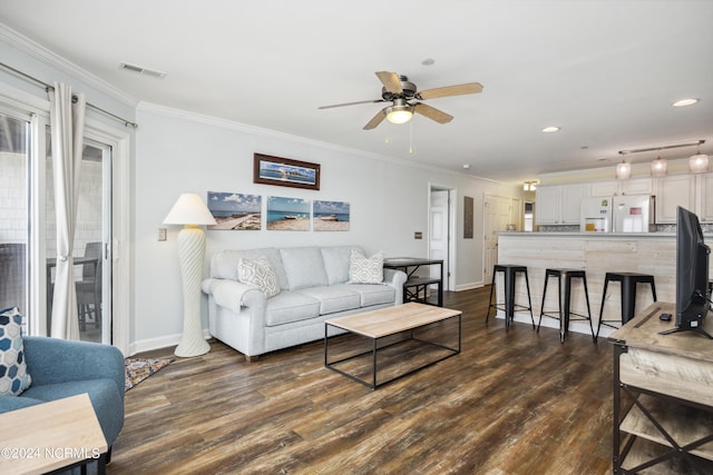 living room featuring ornamental molding, ceiling fan, and dark wood-type flooring