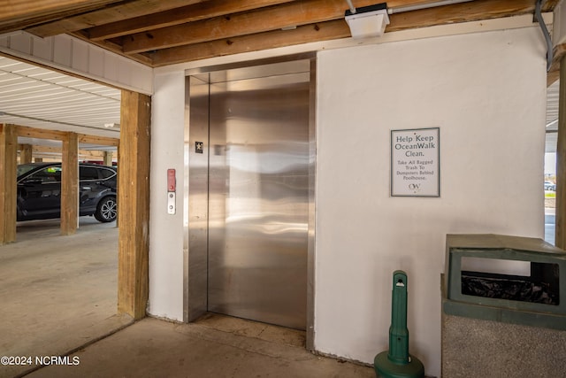 interior space with elevator and concrete floors