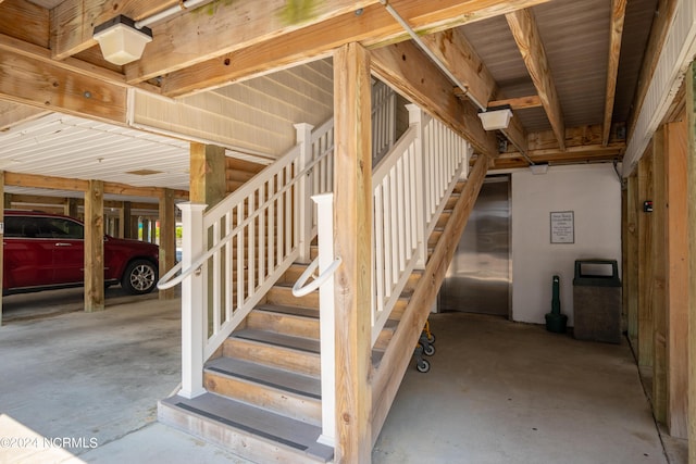 stairs with concrete flooring