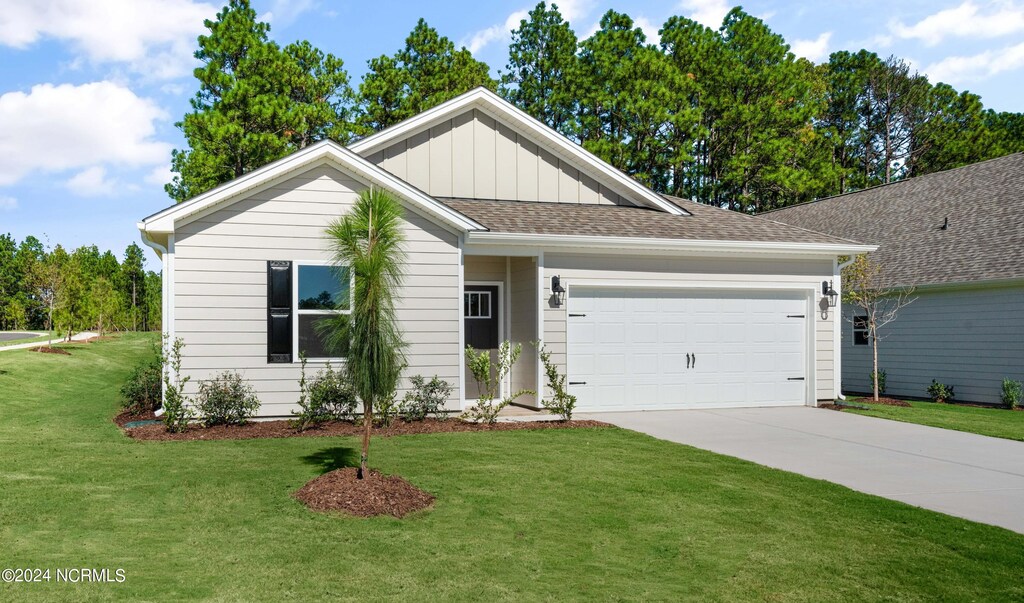 view of front of house with a front yard and a garage