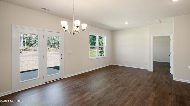 interior space with a chandelier, plenty of natural light, and dark hardwood / wood-style flooring