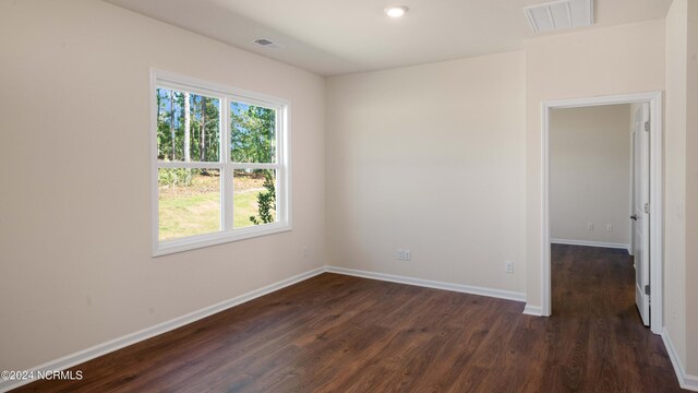 unfurnished room featuring dark wood-type flooring