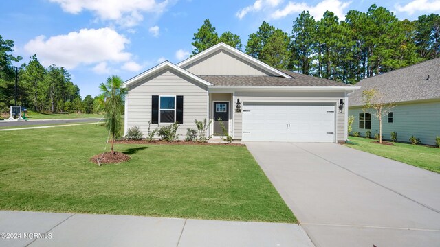 ranch-style house featuring a front lawn and a garage