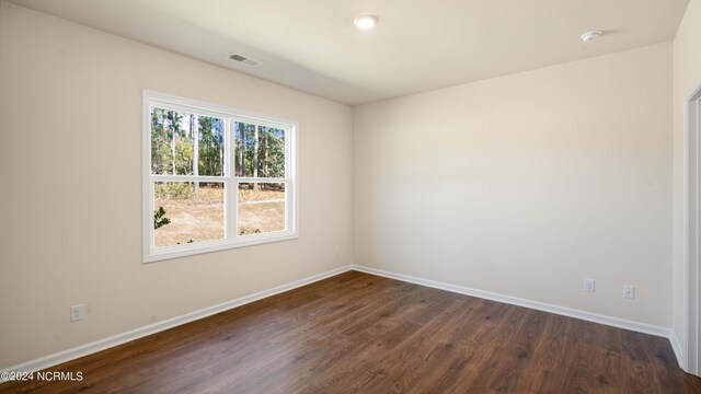 unfurnished room featuring dark hardwood / wood-style flooring