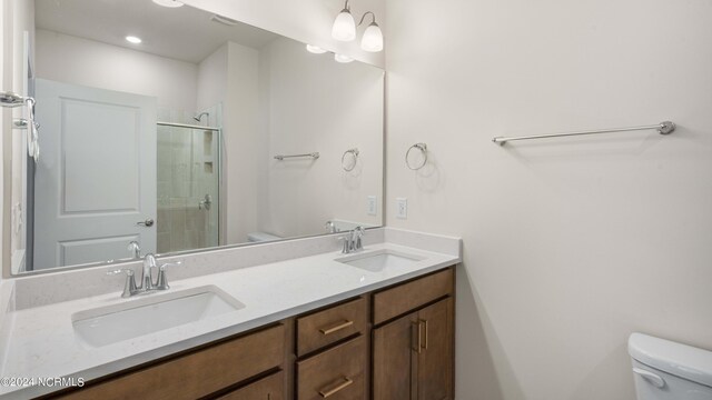 bathroom with vanity, toilet, and an enclosed shower