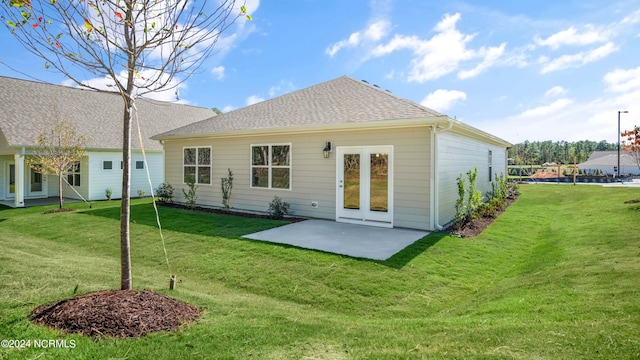 back of property featuring a patio and a lawn