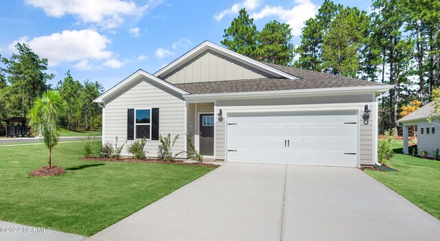 view of front of property featuring a front lawn and a garage