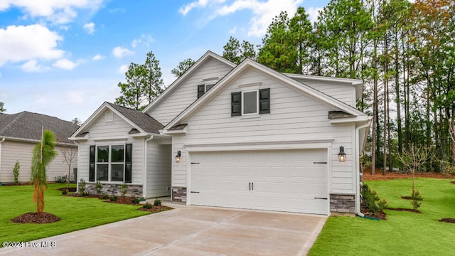 view of front of property featuring a garage and a front lawn