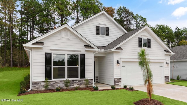 view of front of house with a garage and a front lawn