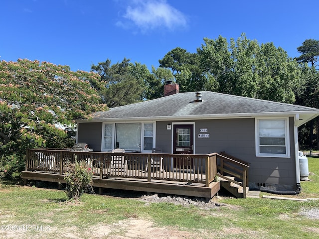 back of house with a wooden deck