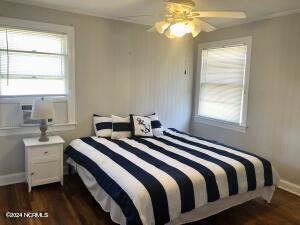 bedroom featuring ceiling fan and dark wood-type flooring