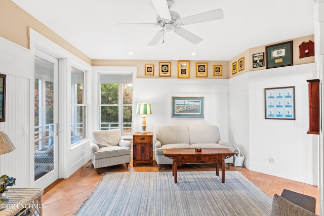 living area featuring light tile patterned floors and ceiling fan