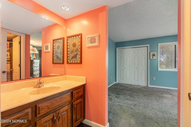 bathroom featuring a textured ceiling and vanity