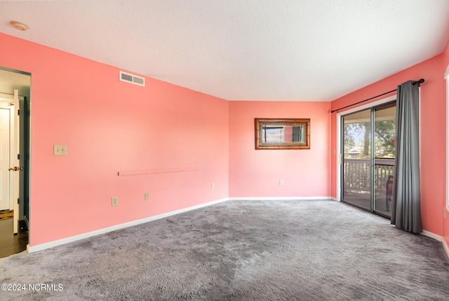 carpeted spare room with a textured ceiling