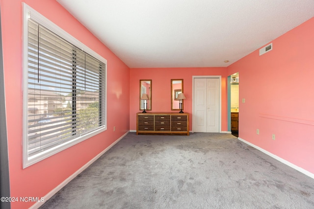 unfurnished bedroom with carpet flooring and a closet