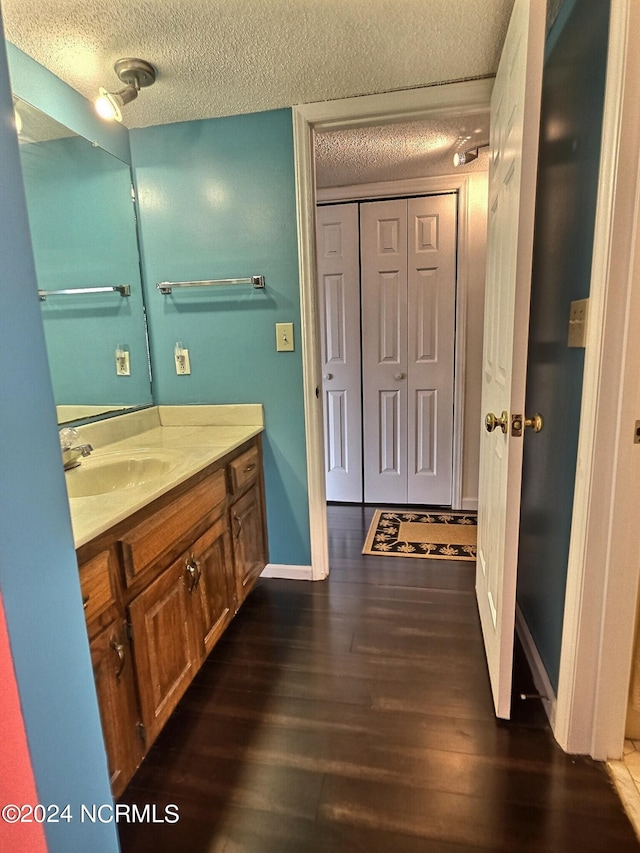 bathroom featuring vanity, a textured ceiling, and hardwood / wood-style flooring