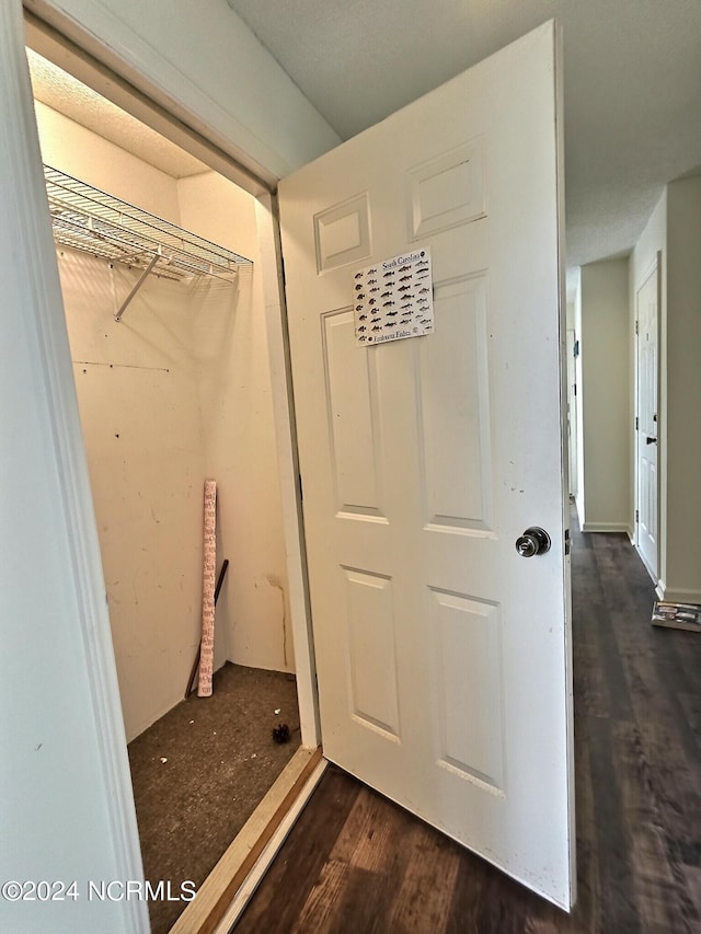 laundry area featuring dark wood-type flooring