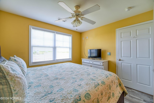 bedroom with a ceiling fan and wood finished floors