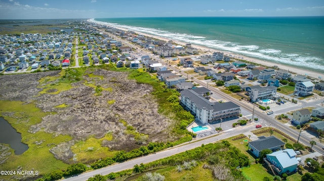 bird's eye view featuring a beach view, a water view, and a residential view