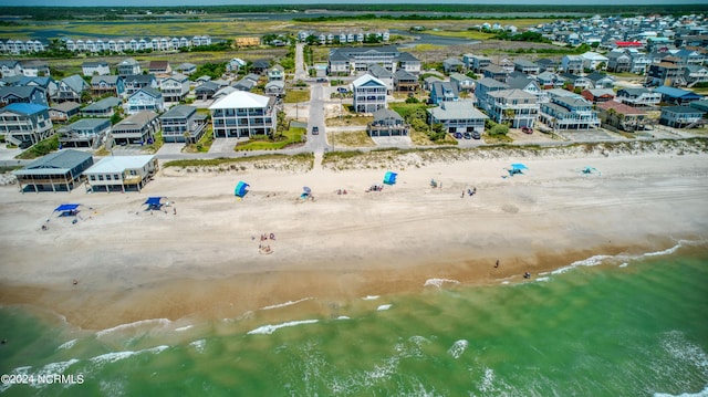 drone / aerial view with a water view, a residential view, and a view of the beach