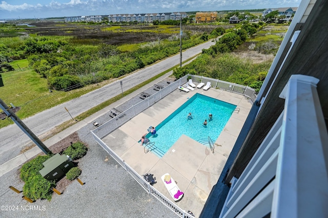 pool featuring fence and a patio