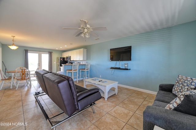 living room featuring recessed lighting, light tile patterned flooring, a ceiling fan, and baseboards