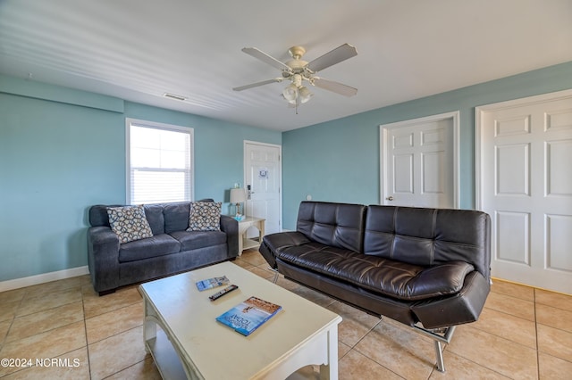 living area featuring ceiling fan, light tile patterned flooring, visible vents, and baseboards