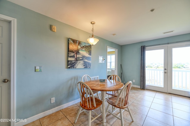 dining space featuring french doors, visible vents, baseboards, and light tile patterned flooring