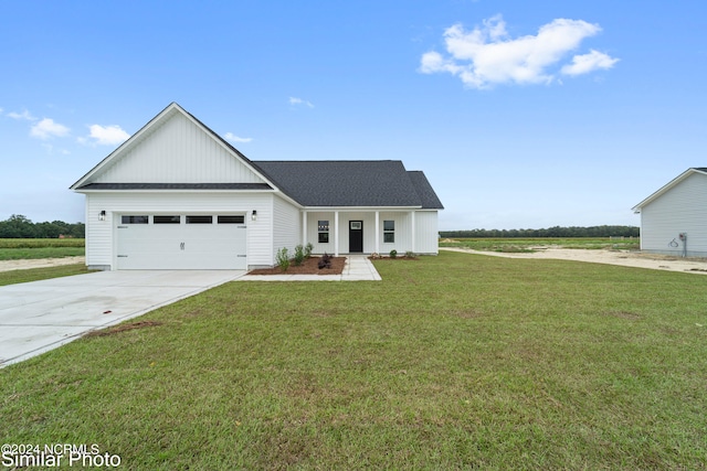 modern farmhouse with a front yard and a garage