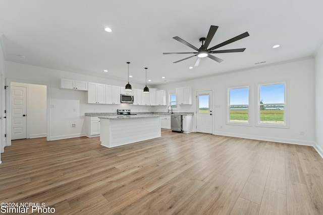 unfurnished living room featuring ceiling fan, sink, light wood-type flooring, and ornamental molding