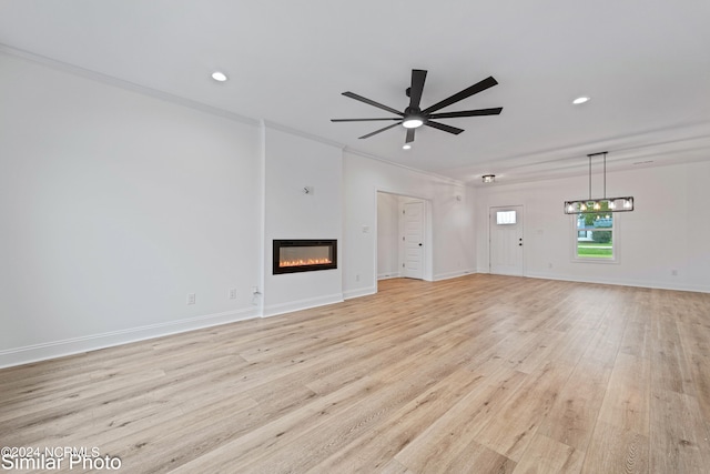 unfurnished living room with crown molding, ceiling fan, and light hardwood / wood-style flooring