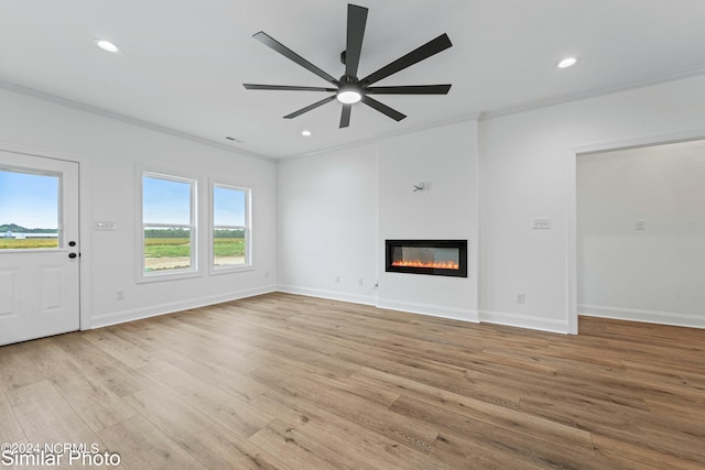 unfurnished living room with ornamental molding, light hardwood / wood-style floors, and ceiling fan