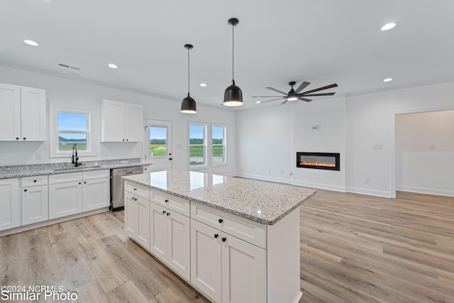 kitchen with stainless steel dishwasher, white cabinetry, sink, and ceiling fan