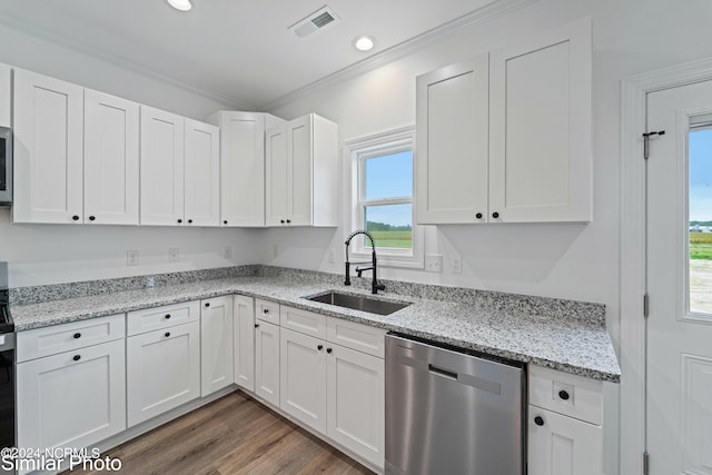 kitchen featuring dark wood-type flooring, sink, white cabinetry, appliances with stainless steel finishes, and ornamental molding